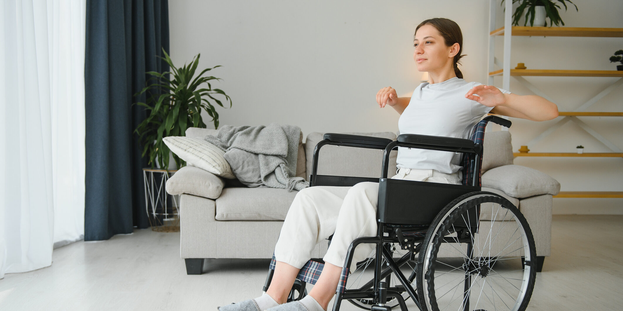 Brunette woman working out on wheelchair at home.
